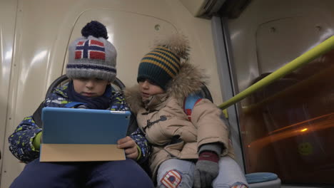 children playing touch pad games on the bus