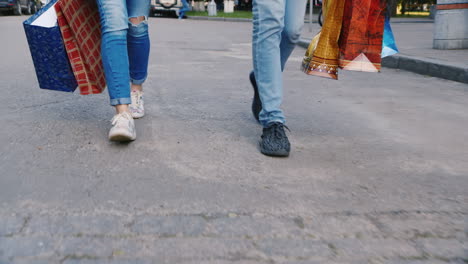 Man-And-Woman-Are-On-The-Sidewalk-With-Shopping-Bags-In-The-Picture-Can-Be-Seen-Only-The-Legs-Hd-Vid