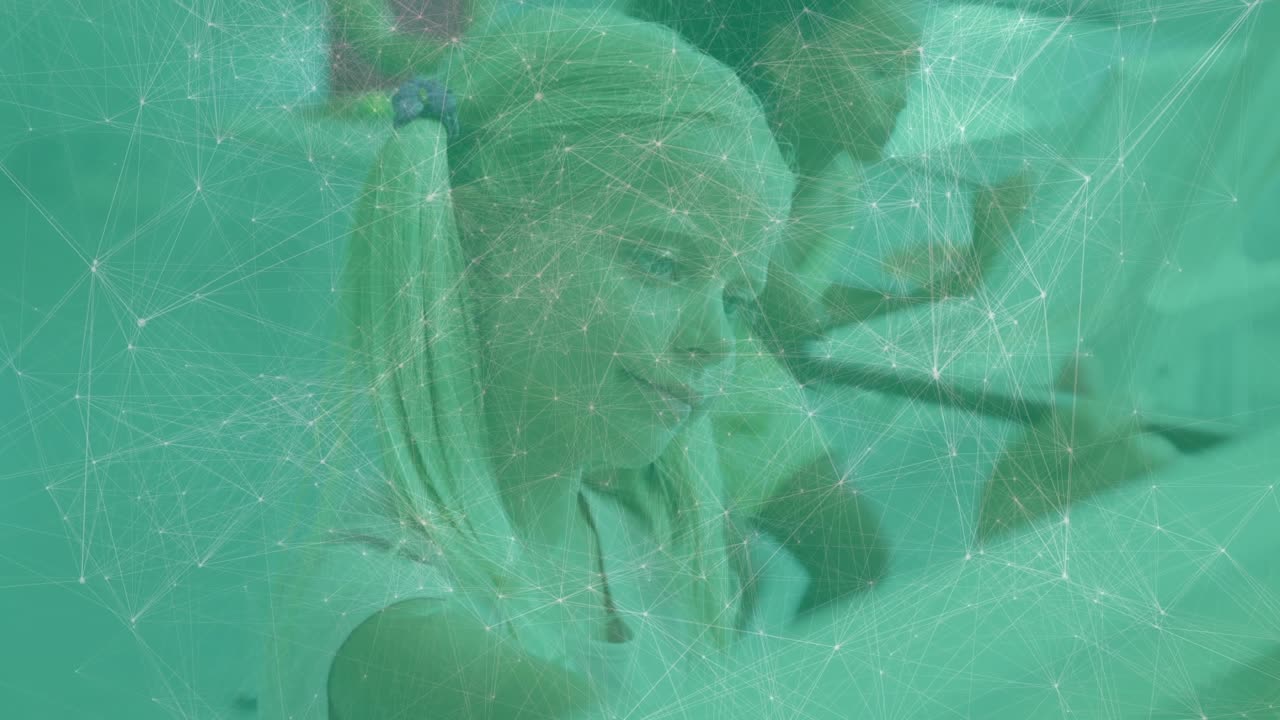 Blonde girl dipping brush into paint making confident marks in art class with floating color guides