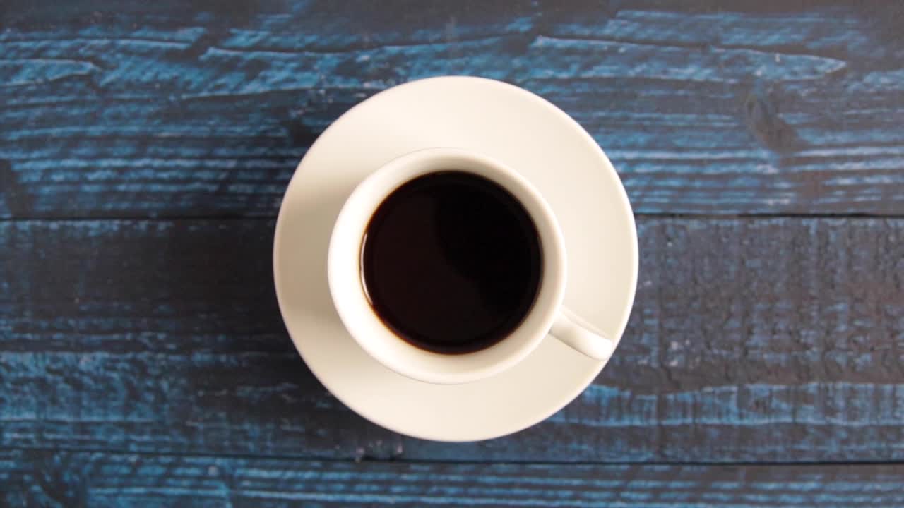 Coffee spinning on a blue table