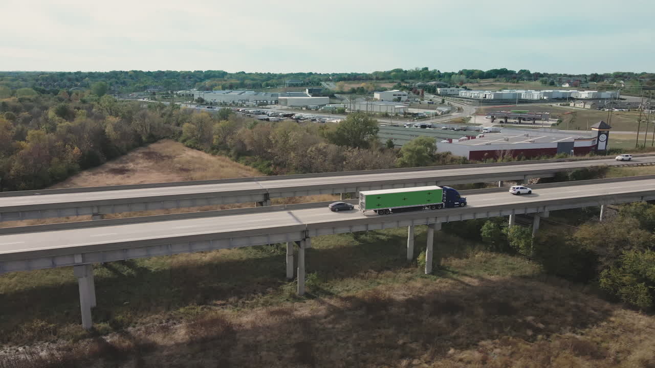 Highway Overpass with Semi-Truck and Cityscape View