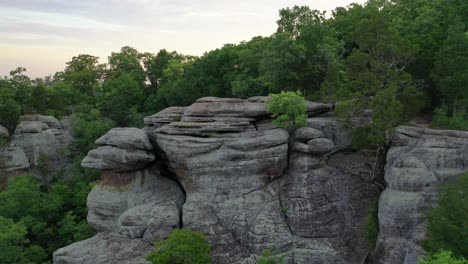 rocky cliff and dense forest landscape in aerial view