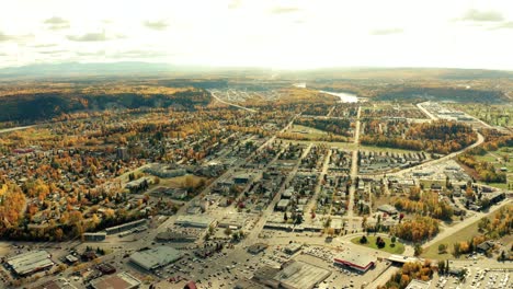 A-cinematic,-aerial-view-of-the-city-of-Prince-George-downtown-area,-including-far-residential-areas-and-some-inner-city-locations-during-the-autumn---fall-season