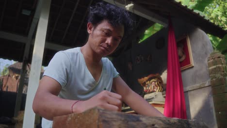 asian craftsman drawing the cutting silhouette on a piece of wood