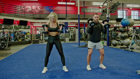 woman and man train on sports training equipment in a fitness gym