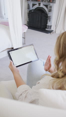 vertical video of caucasian plus size woman using tablet with copy space in slow motion