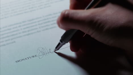 -Close-up-low-angle-shot-of-a-female-caucasian-hand-signing-a-document