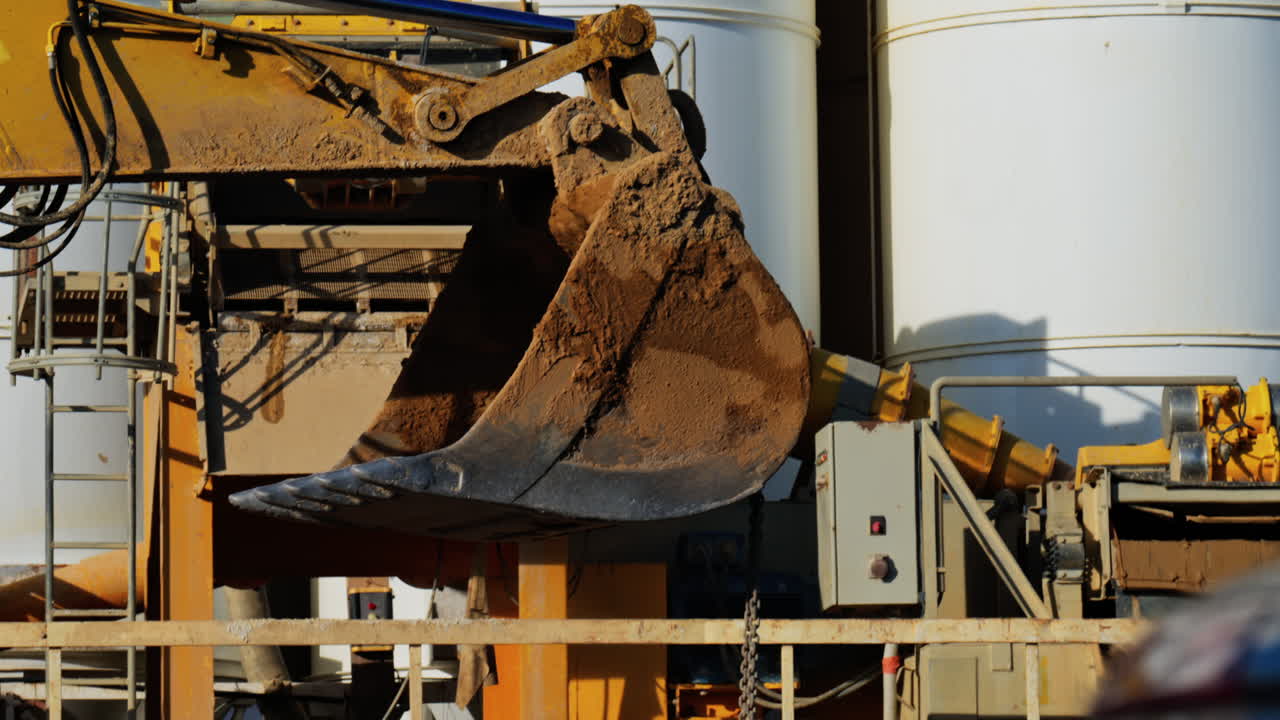 Close up of a yellow crane machine moving and lifting on a construction site