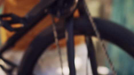 man examining bike wheel chain in yard