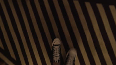 man feet walking in hotel hallway