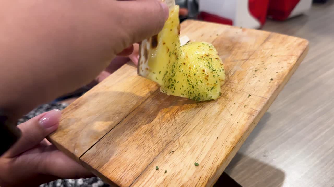 Hands slice and serve a Korean BBQ pizza in a well-lit Bangkok restaurant. Close-up shots highlight the vibrant toppings and casual dining atmosphere