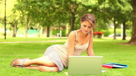 happy student using laptop outside