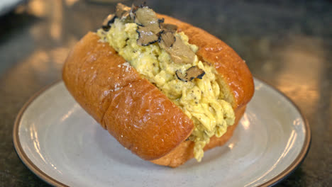 bun or bread with scrambled eggs and truffle mushroom