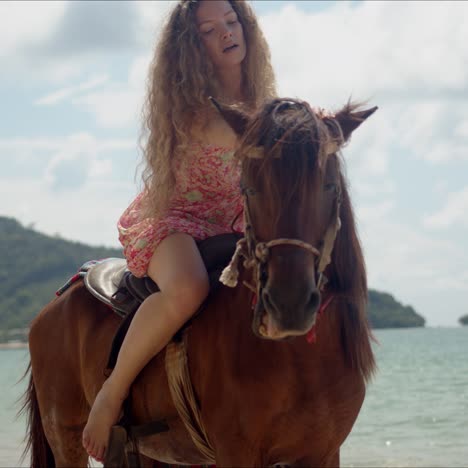 free confident woman riding horse on seaside