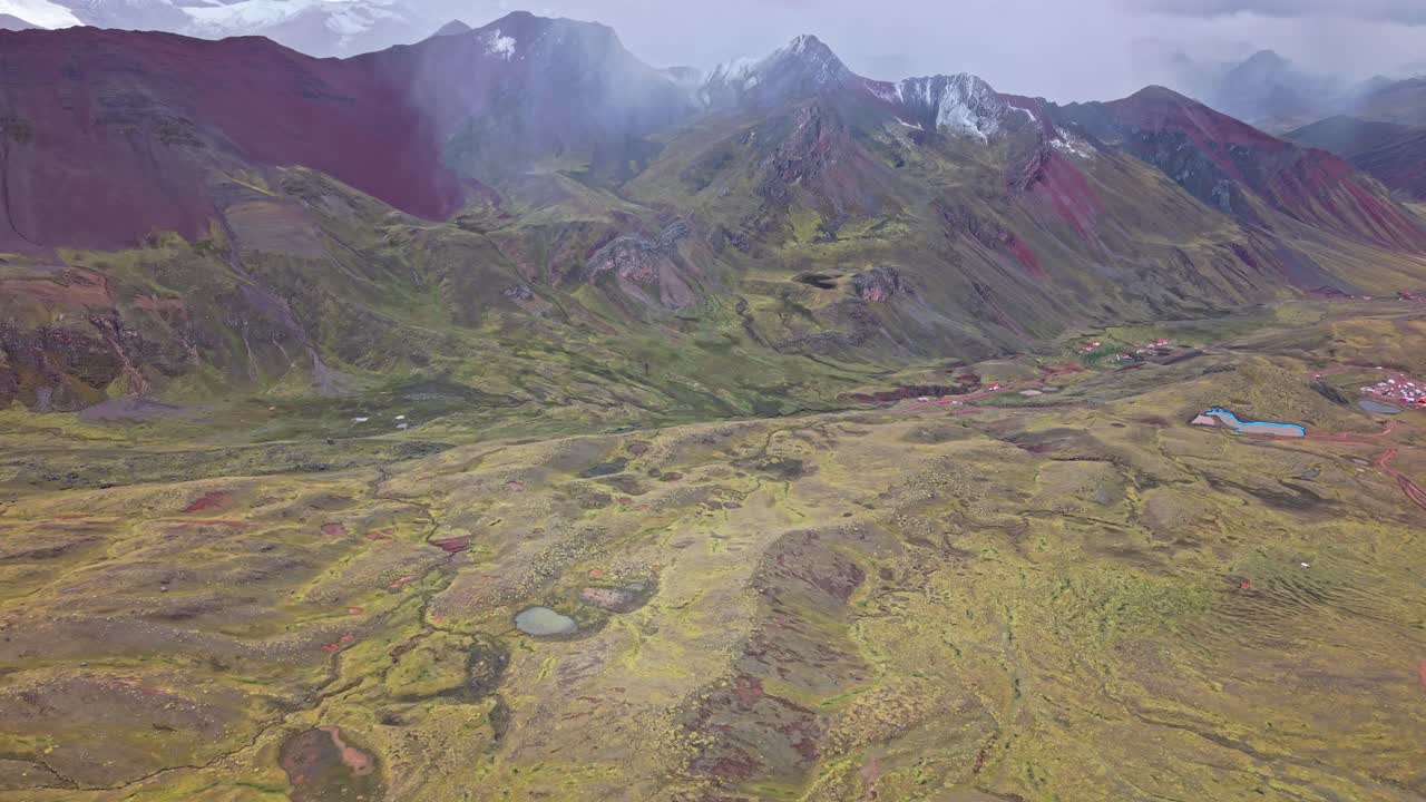 Scenic view of Rainbow Mountain and lush valleys in Peru's highlands