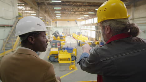 factory engineer and technician discussing manufacturing process