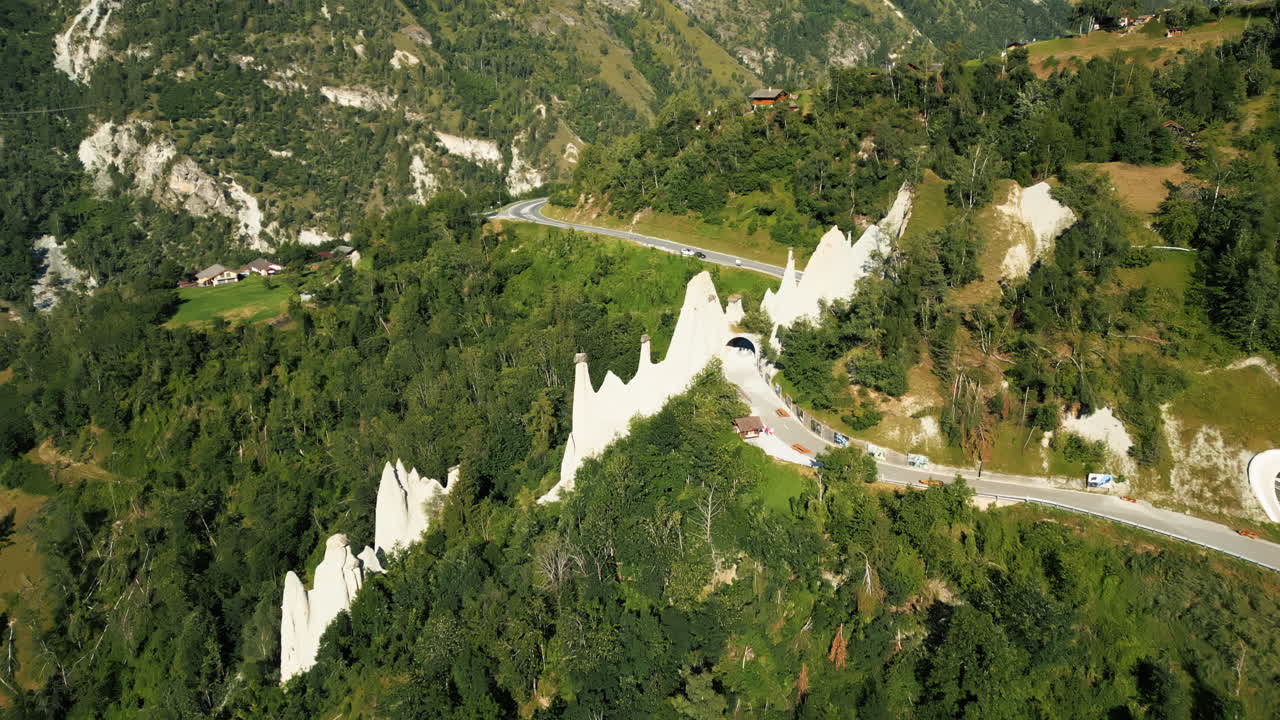 Push in drone shot of fairy chimney rock formations during the day in Euseigne, canton of Valais, Switzerland