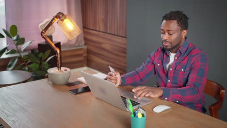man using laptop and credit card