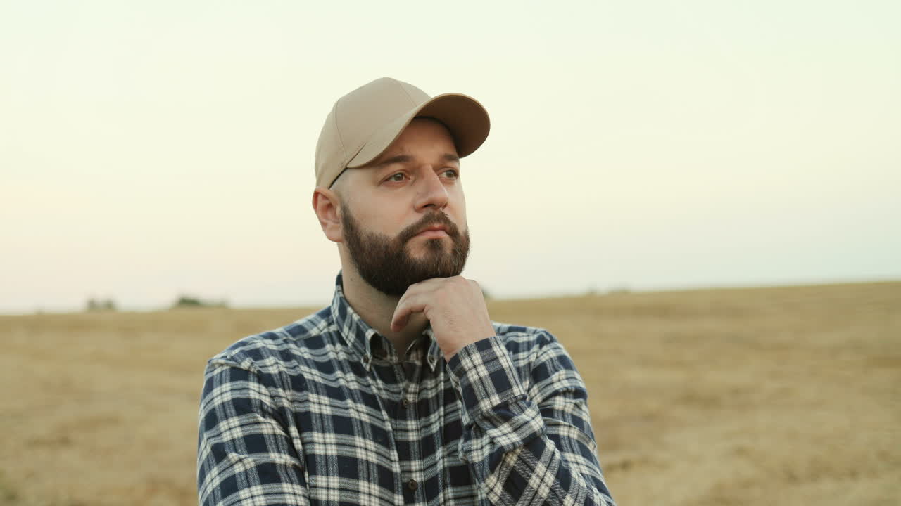 Portrait shot of farmer wearing a baseball cap and thinking about something