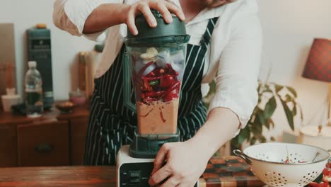 Chef-overloading-grinder-with-bell-pepper-onion-garlic-with-spices