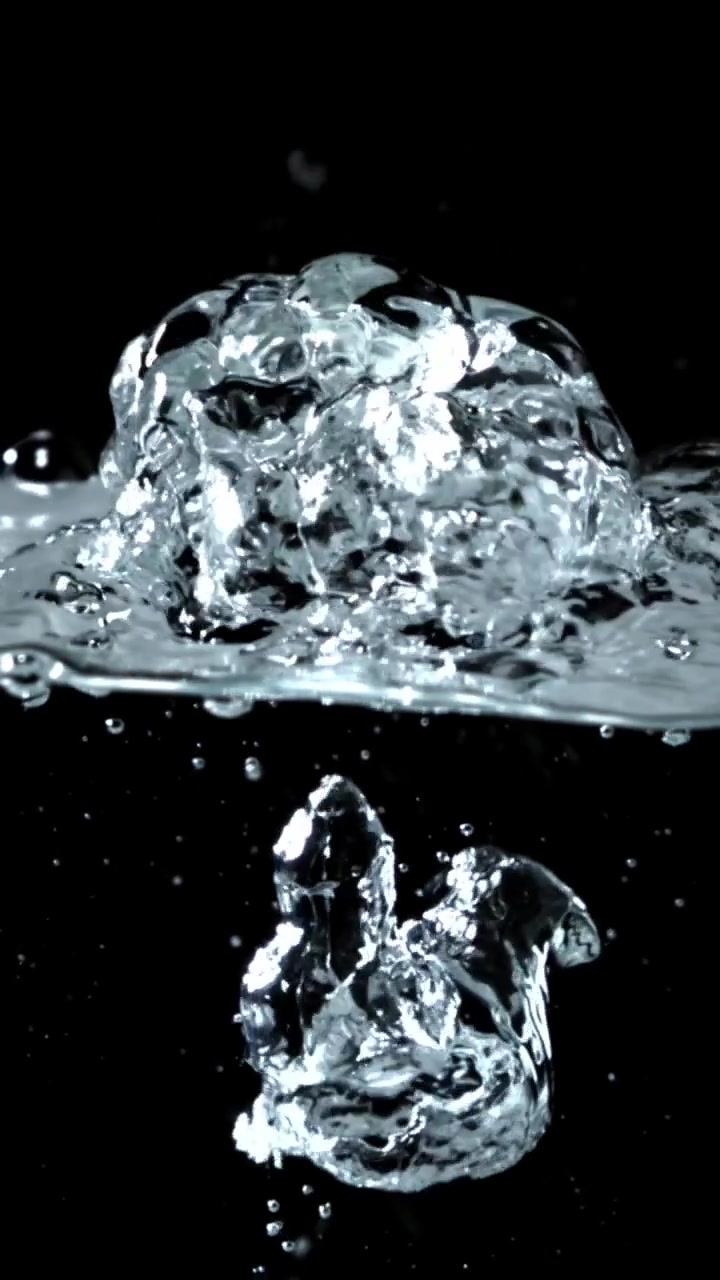 Slow Motion Water Bubbles Rising and Splashing on Black Background