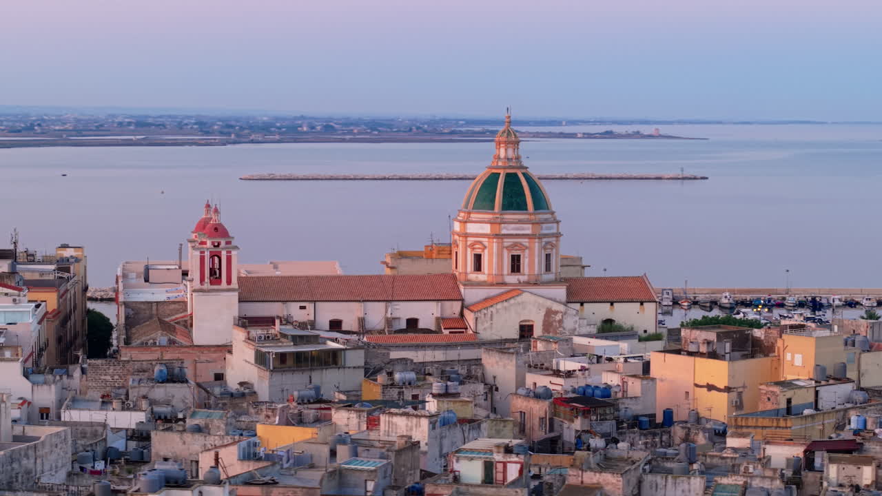 Trapani skyline at sunset with historic domes and coastal view