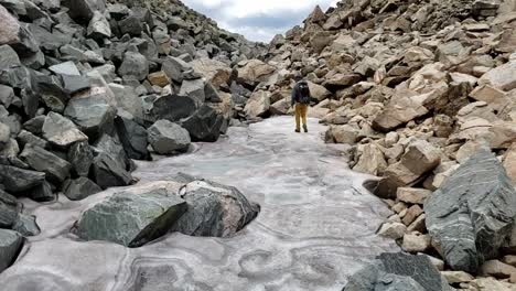 guy walks slowly on snowfield in colorado