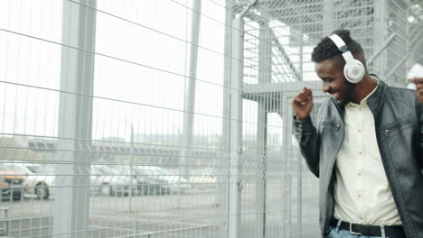 Man Dancing in a Parking Garage with Headphones
