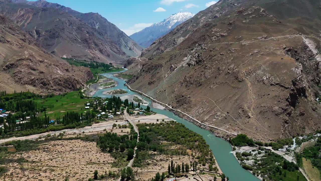 Aerial view of Wakhan Valley corridor, Pamir highway mountains in Central Asia drone above the river that forms the natural border between Tajikistan and Afghanistan
