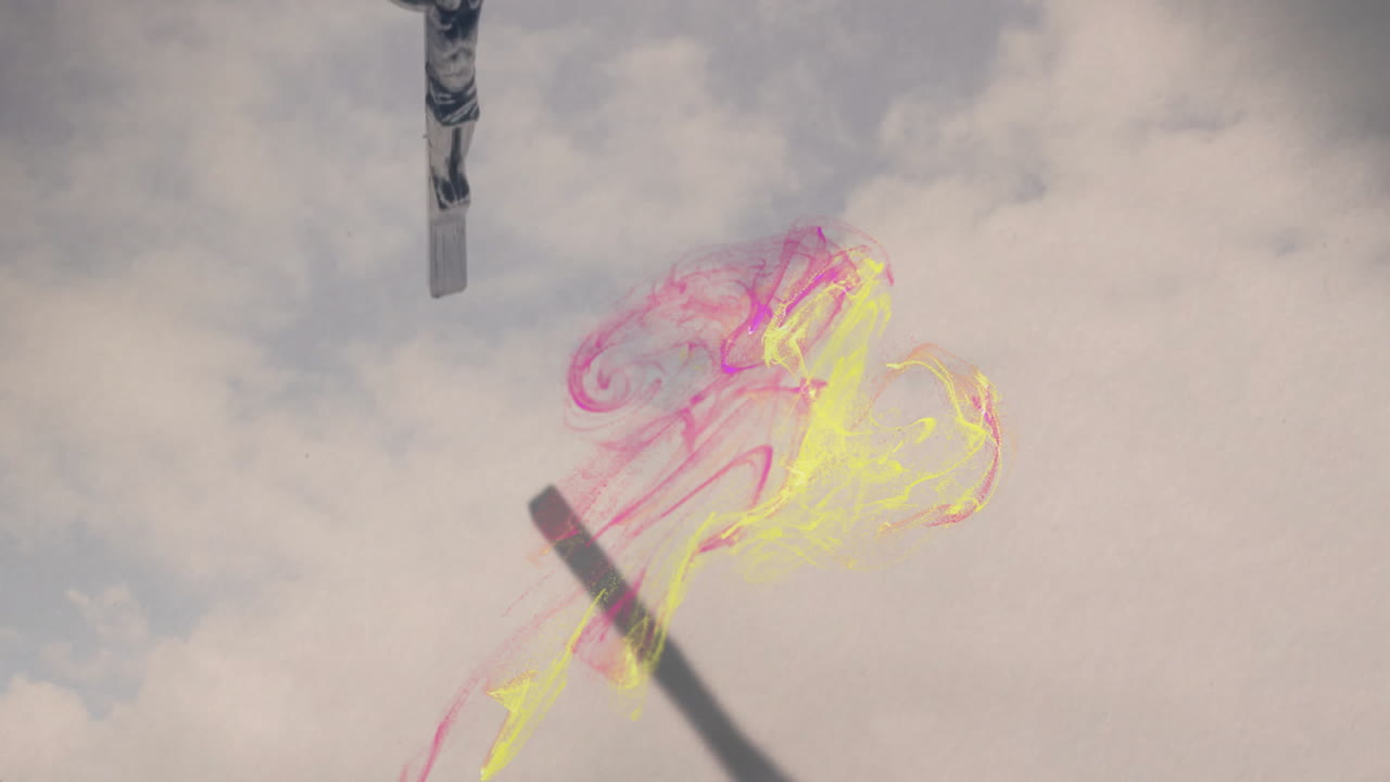 Floating colorful abstract shapes against cloudy sky in animation scene