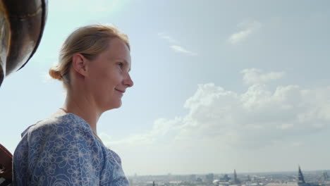 the woman admires the view from a height to copenhagen it stands on top of the church of the savior