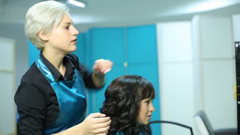 hairdresser cutting hair of her customer. hairdresser cutting hair of her customer at the hairdressing salon