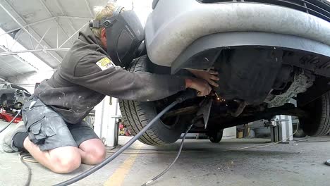 welding a car chassis in the garage