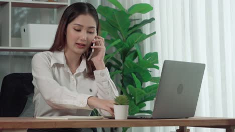 young enthusiastic businesswoman talking on business call and taking note.