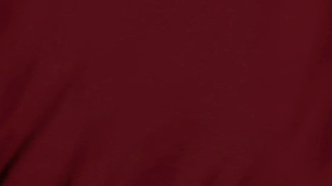 Abstract Background of Dark Red Fabric Waving in the Wind