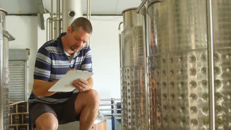 male worker writing on a clipboard 4k