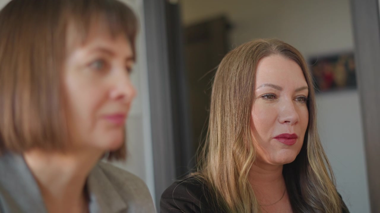 Caucasian songwriter vocal coach collaborating on phrasing and delivery, closeup conversational shots show expressive faces, creative planning in home studio, warm cooperative mood