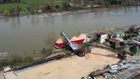 Loading-Barge-Vessel-And-Trans-Mountain-Pipeline-For-Sand-And-Crude-Transportation-Along-Fraser-River-In-British-Columbia,-Canada