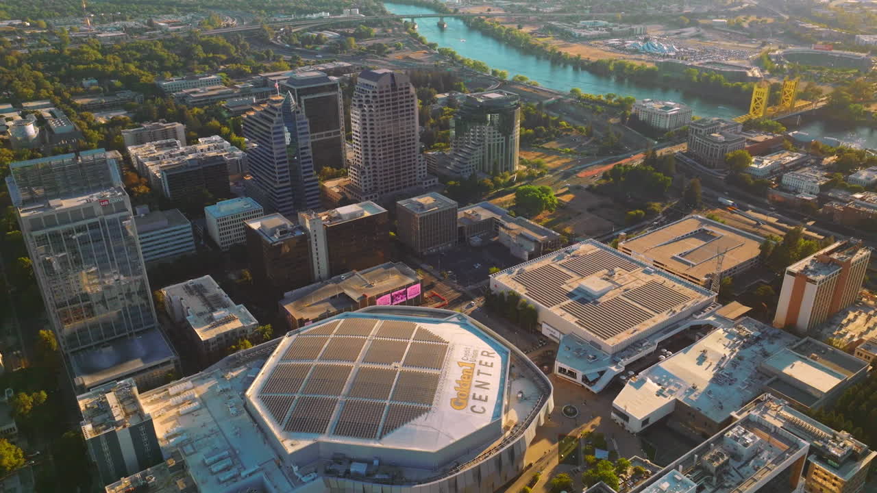 Flying over modern beautiful Sacramento in California State on sunny day. River with bridges over it at backdrop. Top view.