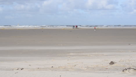 Group-of-vacationers-on-a-stormy-beach