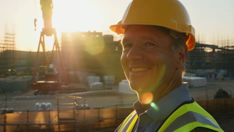 smiling construction engineer at sunset