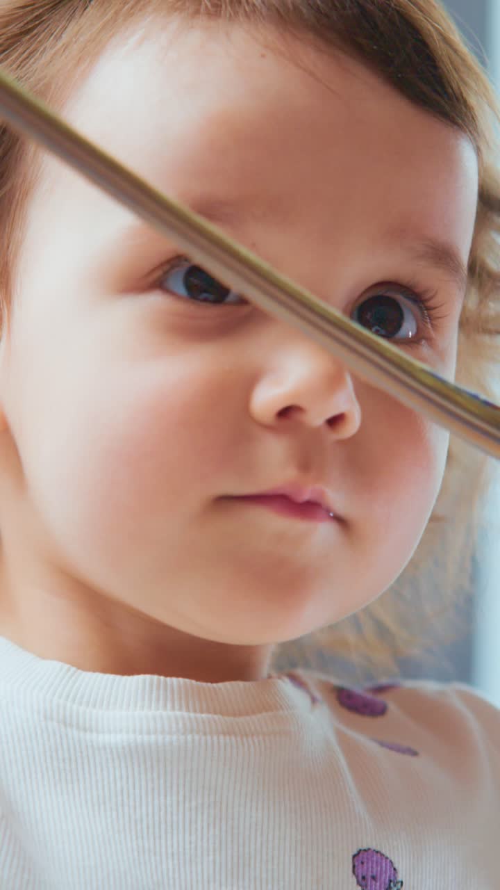 Capturing the Innocent Moments of a Young Child Engaging with a Colorful Toy, Reflecting Curiosity and Joy in Their Expression
