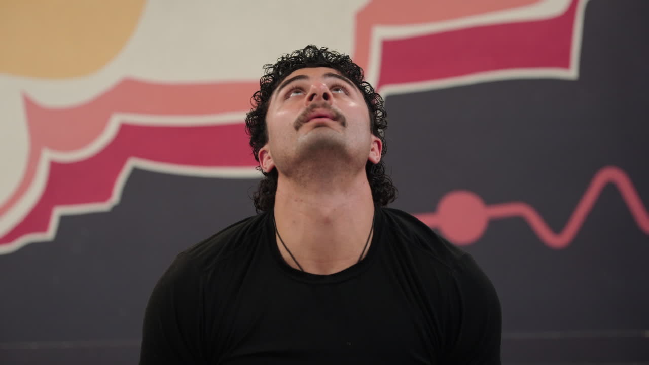 Man doing yoga in the gym, front view