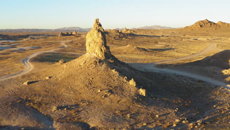 aerial point of interest shot of a big rock formation of the trona pinnacles during the sunrise