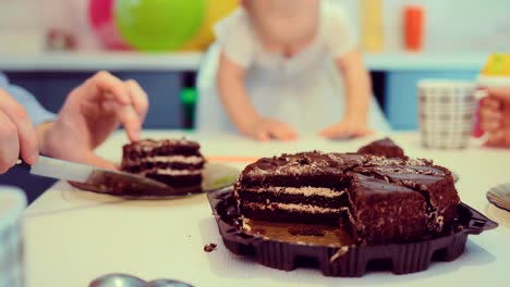 dad puts the pieces of cake on a plate