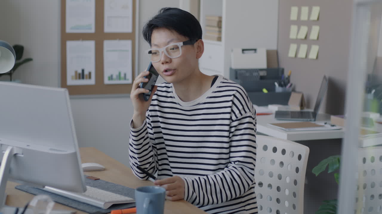 Woman on Phone Call in Modern Office