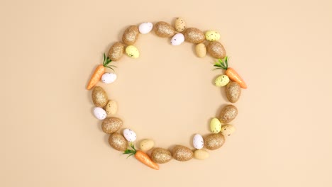 creative circle made of easter eggs and carrots move on nude background. stop motion