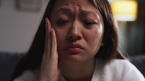 close up of stressed or anxious woman suffering with depression anxiety or loneliness sitting in room at home 2