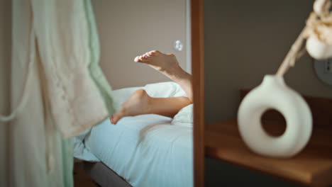 woman feet lying bed in mirror reflection closeup. teenager resting cozy home