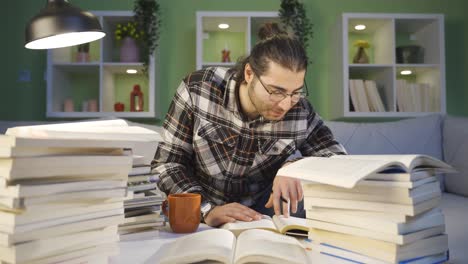 college student male happily studying at home.